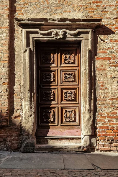 意大利北部皮埃蒙特阿尔巴的老式华丽木门和古老的砖墙 垂直构图 — 图库照片