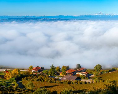 Piedmont, İtalya 'da küçük köy manzarası ve beyaz sabah sisi bulutları.