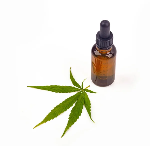 stock image Cannabis oil hemp oil with fresh cannabis leafon bright background