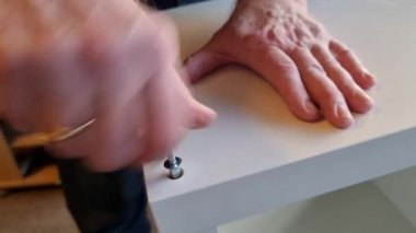 Screw a white shelf together