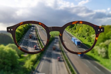 Eye glasses against ametropia sharp panorama view over a Highway without of focus photo parts. 