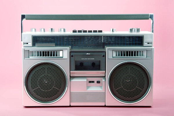 Portable Retro Tapedeck isolated on pink background.