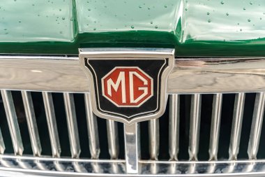 WeTTENBERG, HESSE, ALMANY - 07 - 28 - 2023: Geleneksel Araba Fuarı 'nda İngiliz MG retro Car' ın logosu. MG, 2005 yılına kadar MG Rover Group 'a ait bir İngiliz otomobil markasıydı.