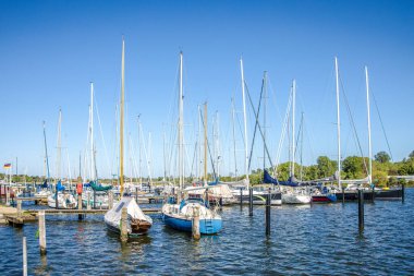 Güneşli bir günde birçok yelkenli Arnis limanında demirliyor..