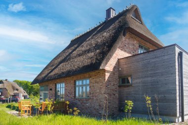 GELTING, GERMANY -  May 14,  Holiday resort in Geltinger Birk with traditional thatched-roof houses. clipart