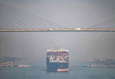 Al Salam Köprüsü 'nün altında Süveyş Kanalı' nda büyük kargo gemileri. Ulaşım ve lojistik kavramı.