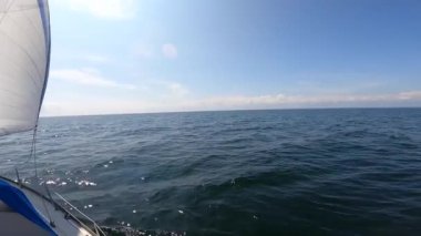 Sailboat with open sails in sea in slow motion. Concept of travel, adventure, vacation.