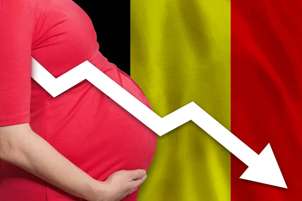 Belgian pregnant woman on Belgian flag background. Falling fertility rate in Belgium