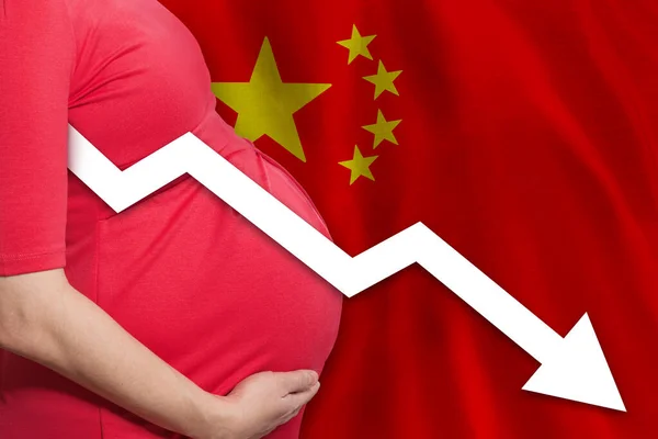 Chinese pregnant woman on Chinese flag background. Falling fertility rate in China