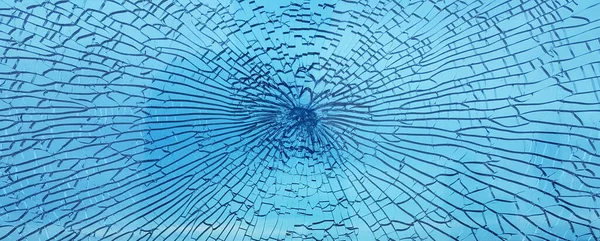 Abstract blue broken cracked glass shot window against sky background