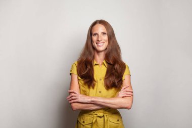 Mutlu gülümseme orta yaşlı iş kadını beyaz arka planda duruyor, stüdyo portresi