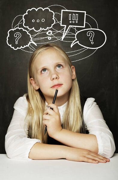 Pupil thinking in classroom, education concept, girl with question mark icons above her head