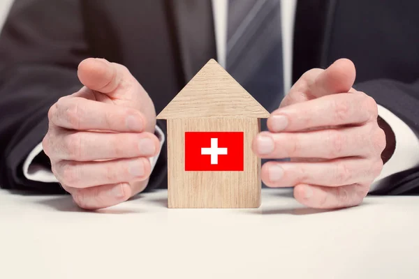 Businessman Hand Holding Wooden Home Model Swiss Flag Insurance Property — Stock Photo, Image