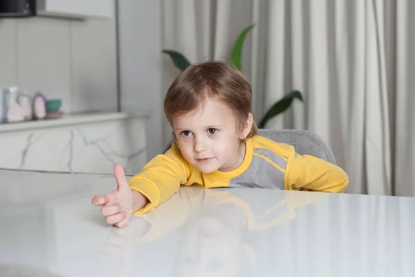 Smiling Happy Child Boy Yellow Sweater Sitting Table Pulling Hand — Stock Photo, Image