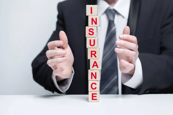 stock image Wooden blocks with black word insurance, fragile pyramid, business insurance safety concept