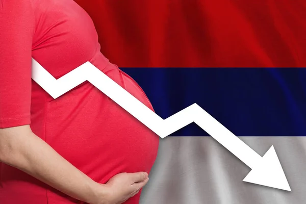 Serbian pregnant woman on Serbian flag background. Falling fertility rate in Serbia