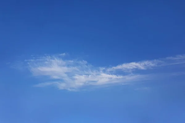 青い明るい空の背景に白いふわふわした雲 — ストック写真