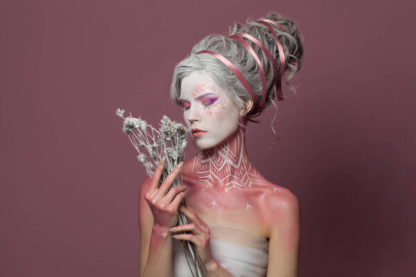 Cold beauty. Halloween model with dried flower. Witch woman, fashion beauty studio portrait