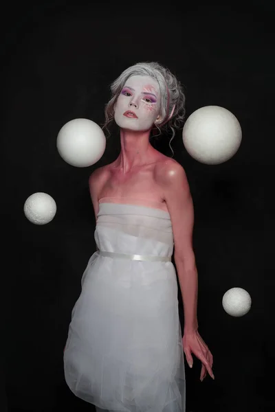 Snow queen woman standing on black background. Creative winter model