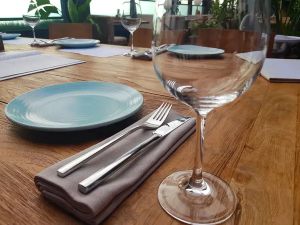 Table setting with cutlery and napkin in restaurant closeup