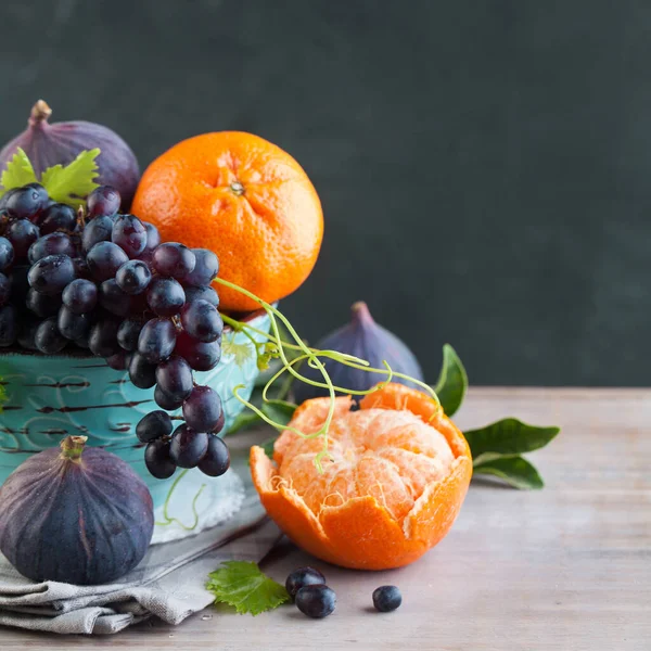 Bright fruit in bowl on wooden table, healthy food background
