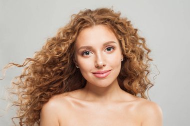 Uzun, sağlıklı, dalgalı saç stili, beyaz arka planda mükemmel temiz cilt, moda güzellik anlayışı olan çekici kızıl saçlı bir kadın.