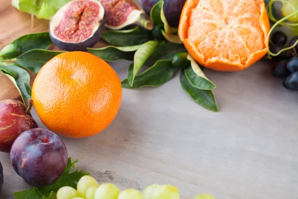 Summer fruit background border on grey wooden board table. Organic food