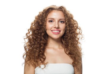 Oldukça sağlıklı genç bir bayan portresi. Uzun kıvırcık saçlı, doğal makyajlı ve beyaz tenli mükemmel bir kadın. Güzellik, saç şekillendirme, cilt bakımı ve estetik cerrahi konsepti.