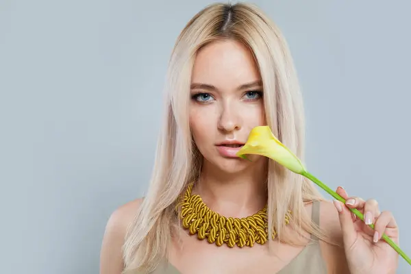 Attractive fashion jewelry model woman. Lady with fresh clean skin, blonde hair and yellow necklace on her neck
