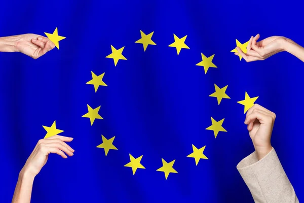 Human hands with gold stars on European Union flag background. EU candidate concept