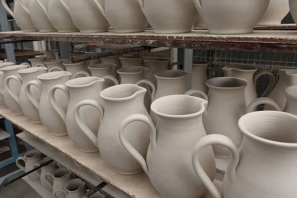 Pottery left out to dry before firing. Ceramic pitcher jugs.