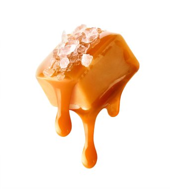 Flying salty caramel candy topped with salt crystals and pouring caramel sauce isolated on white background clipart