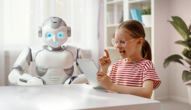 Tatlı bir kız bir robotla oynuyor. Gelecekteki eğitim kavramı. 