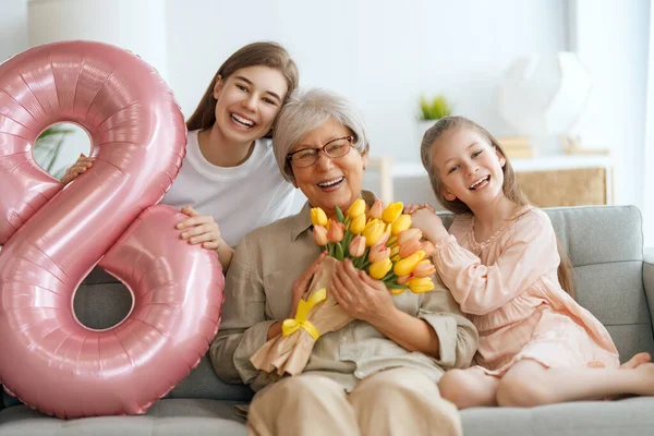 Happy Mother Day Children Daughters Congratulating Grandmother Giving Her Flowers — Stock Photo, Image