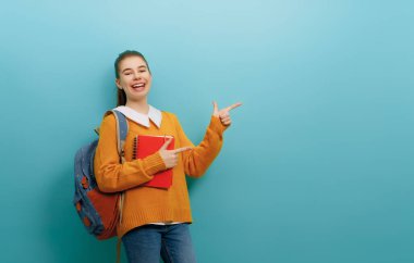 Okula ve mutlu zamanlara. Duvar kağıdının arka planında sevimli, çalışkan bir genç. Sırt çantalı kız. Çalışmaya hazır gençler..