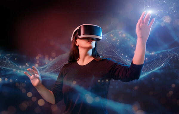 Metaverse technology concept. Woman with VR virtual reality goggles. Futuristic lifestyle.