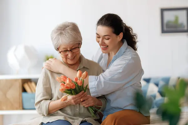 Beautiful Young Woman Her Mother Flowers Tulips Hands Home Stock Image