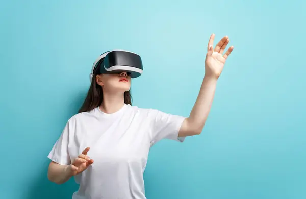 Metaverse Technologie Concept Vrouw Met Virtual Reality Bril Lichtblauwe Muurachtergrond Rechtenvrije Stockafbeeldingen