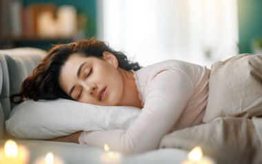 Güzel genç bir kadın evdeki yatak odasında uyuyor..