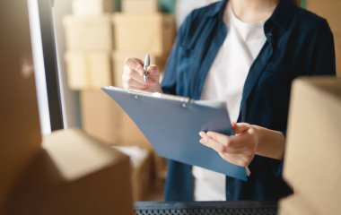 Kadın envanter müdürü stokları kontrol ediyor. Depoda çalışan bir kadın.. 