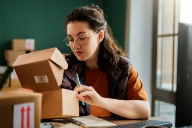 Kadın envanter müdürü stokları kontrol ediyor. Depoda çalışan bir kadın.. 