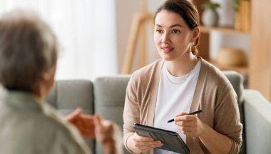 Psikolog resepsiyonundaki yaşlı kadın hastaya danışmanlık.