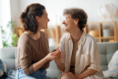 Mutlu hasta ve bakıcı birlikte vakit geçiriyor. Büyük kadın ve yetişkin kızı..
