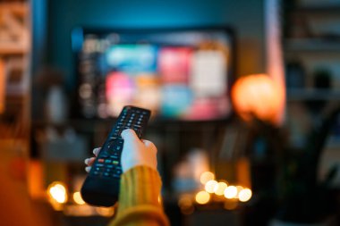 Using remote control while watching tv.