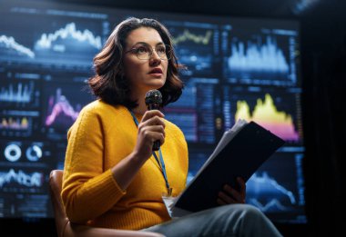 A young woman is giving a presentation at a conference.