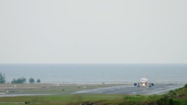 Passenger airplane acceleration before takeoff at Phuket airport, front view. Tourism and travel concept