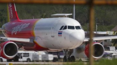 PHUKET, THAILAND - NOVEMBER 26, 2016: Commercial jet plane Airbus A320 of VietJet Air taxiing on the runway before takeoff at Phuket International airport. Tourism and travel concept