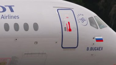 MOSCOW, RUSSIAN FEDERATION - JULY 28, 2021: Side view, Sukhoi Superjet 100 of Aeroflot taxiing at Sheremetyevo airport. Civil aircraft on the taxiway. Tourism and travel concept