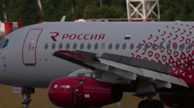 MOSCOW, RUSSIAN FEDERATION - JULY 29, 2021: Jet plane of Rossiya braking after landing at Sheremetyevo airport, side view. Tourism and travel concept