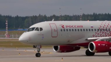 MOSCOW, RUSSIAN FEDERATION - JULY 29, 2021: Passenger jet airplane of Rossiya taxiing to Sheremetyevo airport, side view. Tourism and travel concept